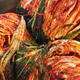 whole heads of cabbage kimchi in bowl